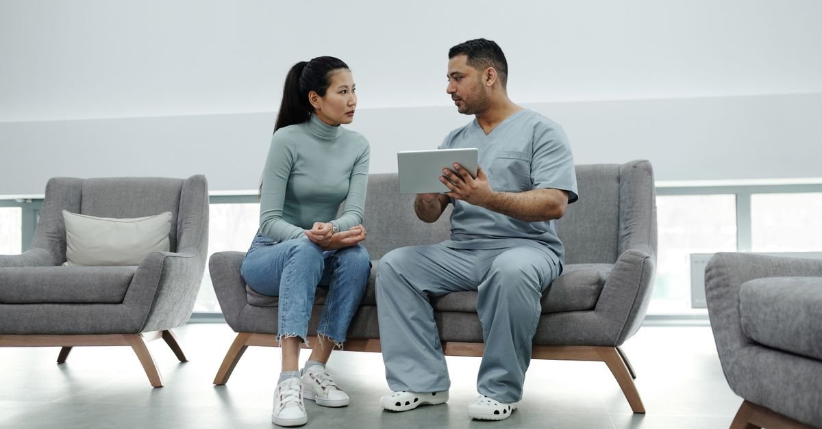 Patient and clinician talking in a bright consulting room about midlife memory changes